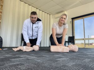 two students practice cpr on manakins in bridgeman downs