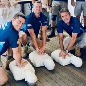 a team of workers practices first aid in a class